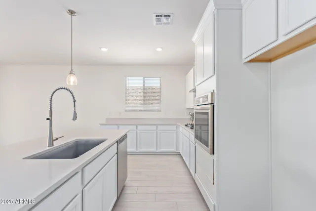 a kitchen with a sink and refrigerator