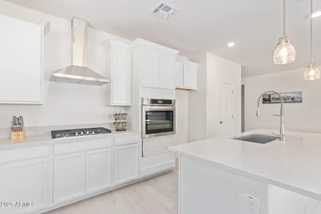 a kitchen with cabinets and window