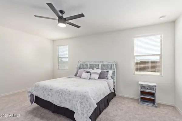 a bedroom with a bed a dresser and a window
