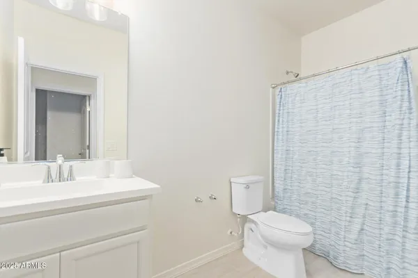 a bathroom with a toilet a sink and a mirror