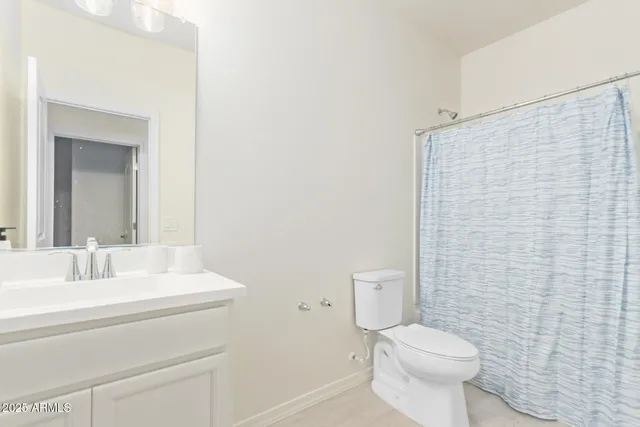 a bathroom with a toilet a sink and a mirror