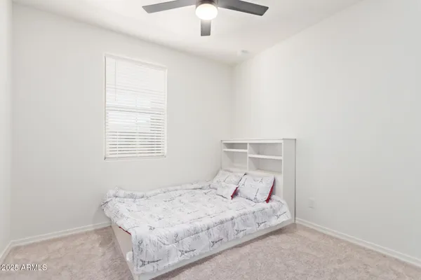 a bedroom with a bed and window