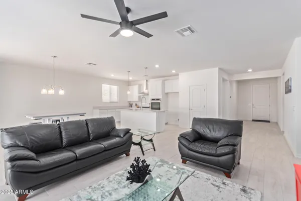 a living room with furniture and kitchen view
