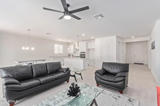 a living room with furniture and kitchen view