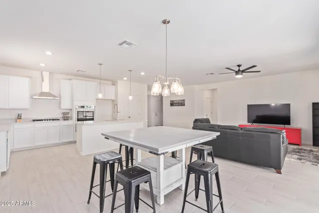 a kitchen with a table and chairs in it