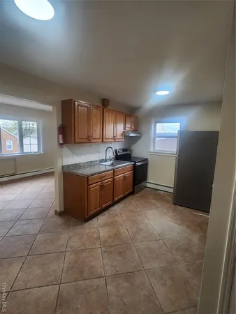 a kitchen with stainless steel appliances granite countertop a stove a sink a refrigerator and a granite counter tops
