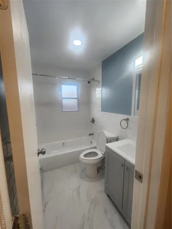 a bathroom with a toilet a sink a shower and mirror