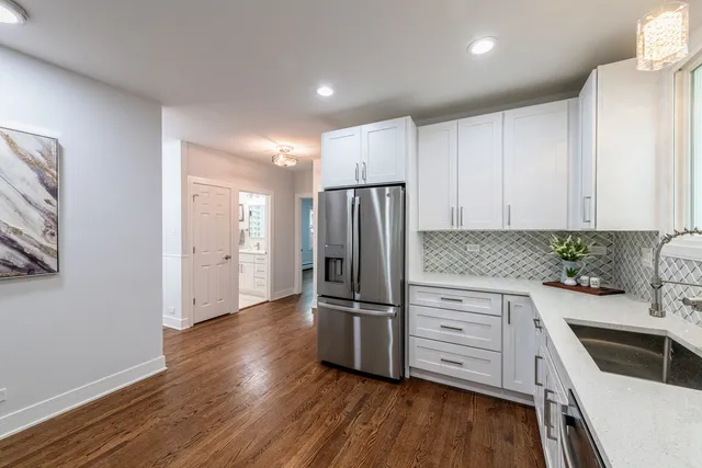 a kitchen with granite countertop a refrigerator and a sink