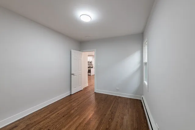 a view of an empty room and wooden floor