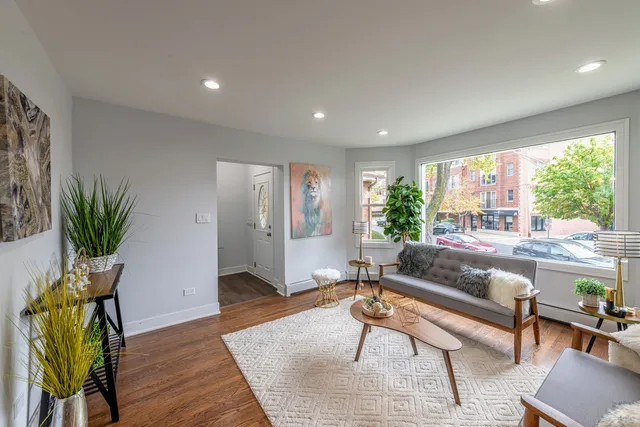 a living room with furniture and a potted plant