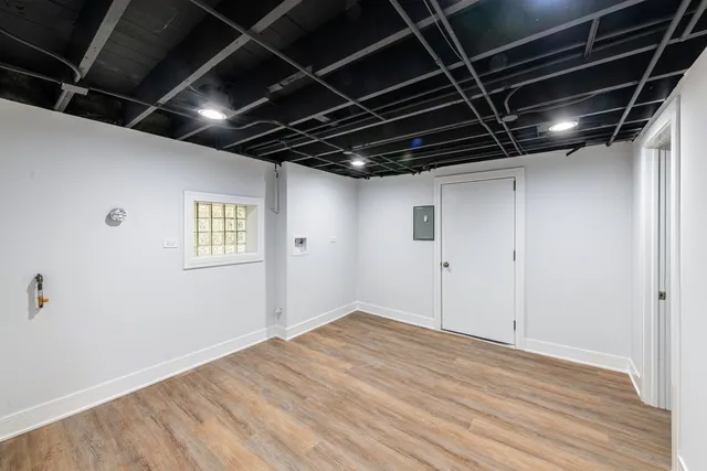 a view of empty room with wooden floor