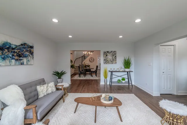 a living room with furniture and wooden floor