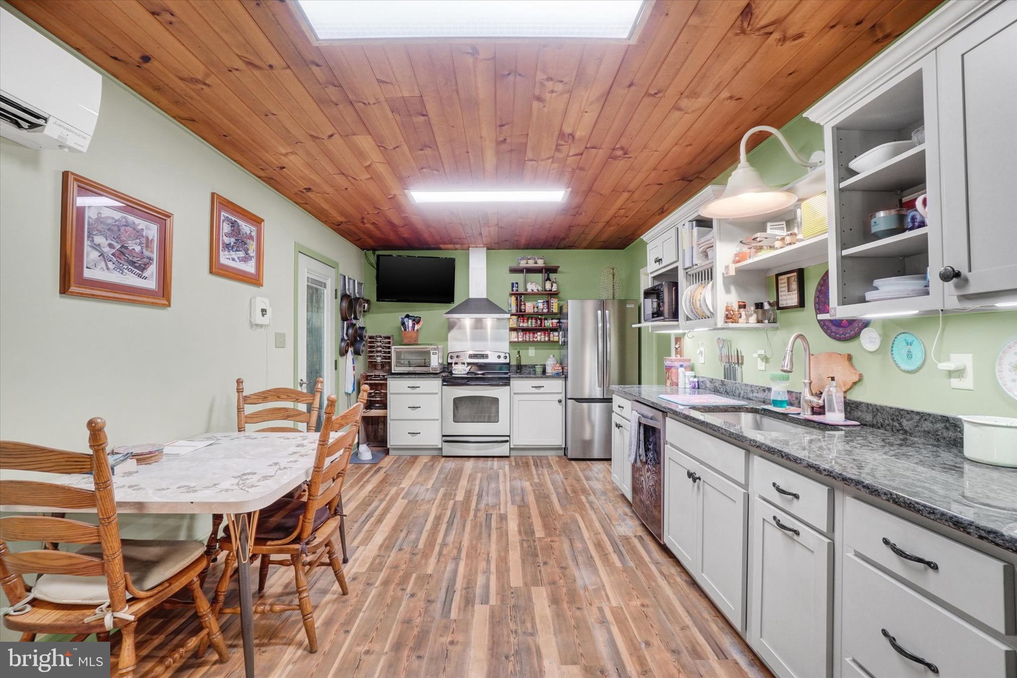 127 Halls Road Red Lion, PA 17356 - Photo 15 of 133 a kitchen with stainless steel appliances granite countertop lots of counter top space and wooden floors