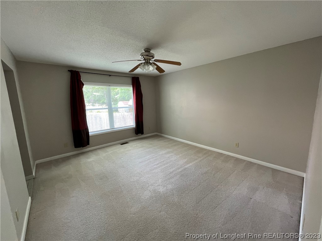 3308 Arrowhead Road Spring Lake, NC 28390 - Photo 11 of 13 an empty room with windows and fan