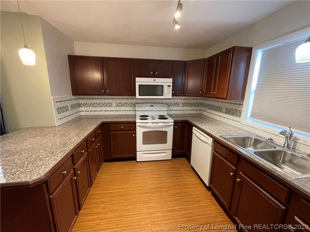 3308 Arrowhead Road Spring Lake, NC 28390 - Photo 3 of 13 a kitchen with stainless steel appliances granite countertop a stove a sink and a microwave