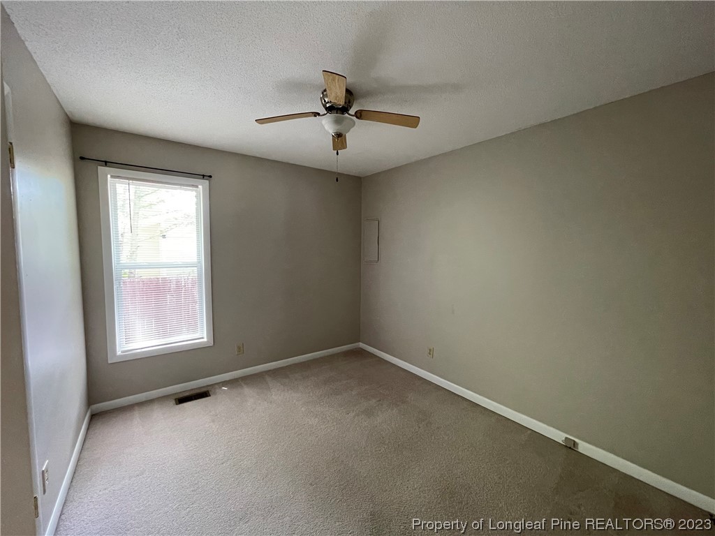 3308 Arrowhead Road Spring Lake, NC 28390 - Photo 10 of 13 an empty room with windows and ceiling fan