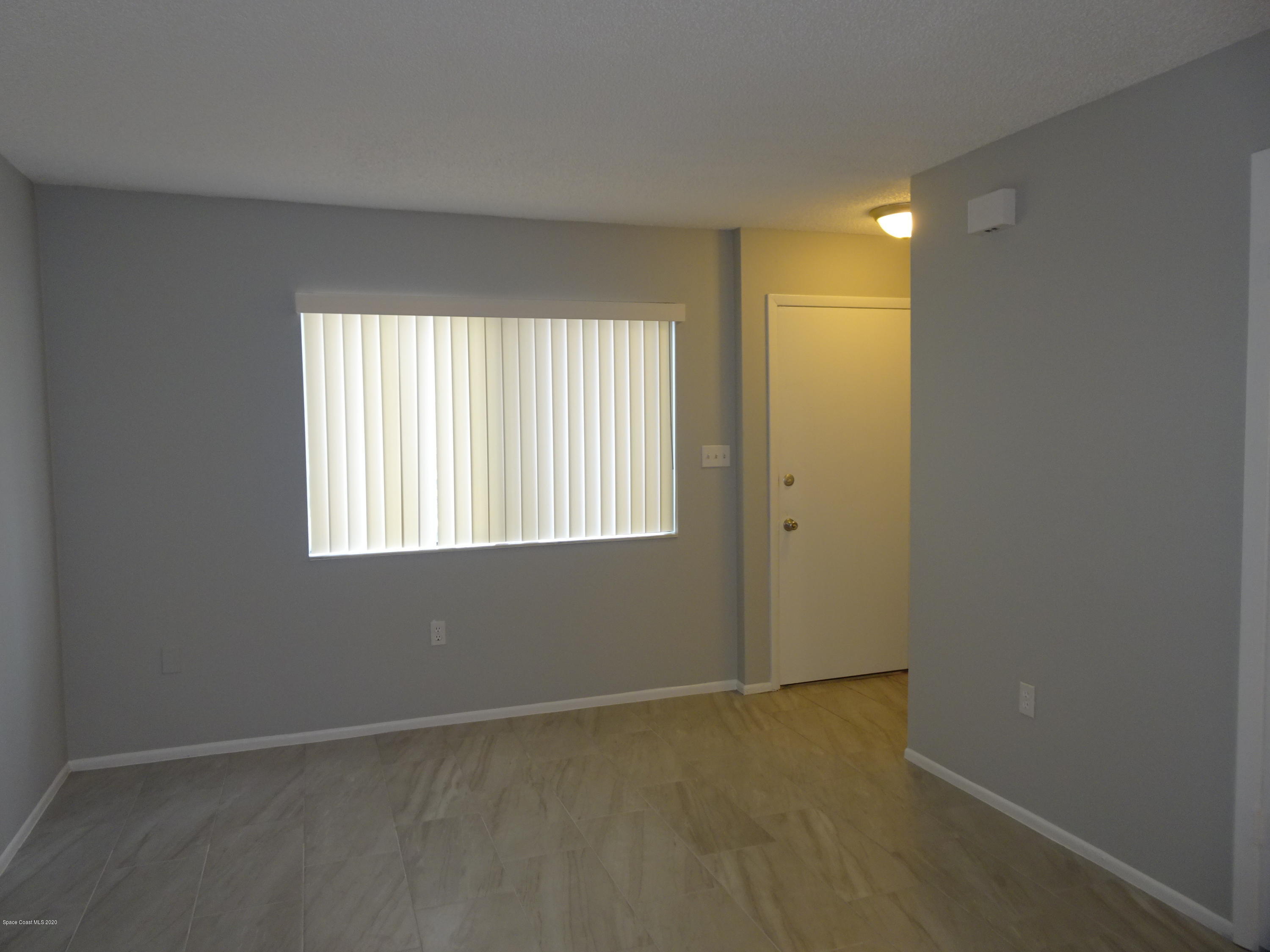 4875 Sisson Road Titusville, FL 32780 - Photo 5 of 14 an empty room with windows