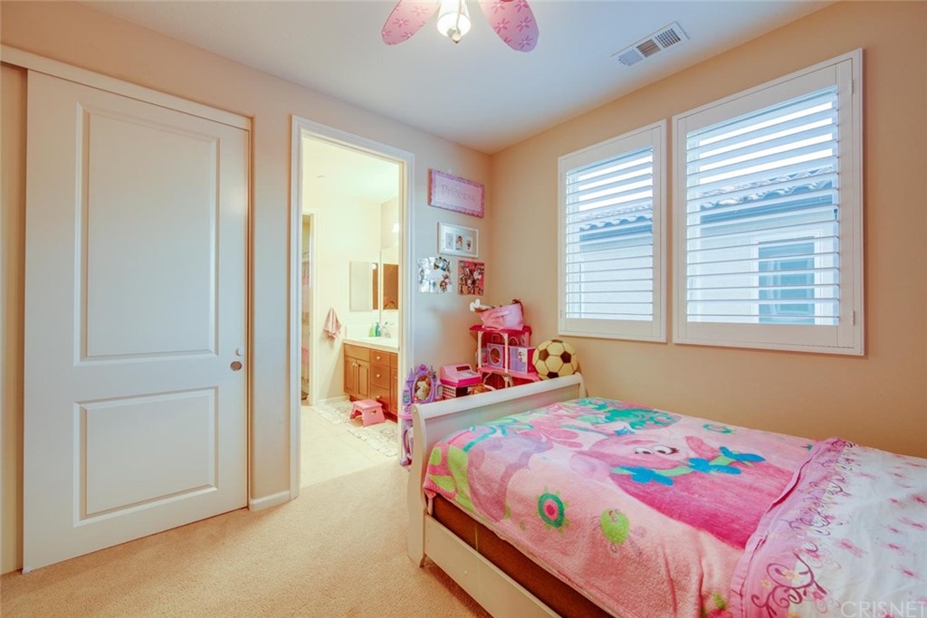 20855 Piazza Way Porter Ranch, CA 91326 - Photo 13 of 38 a bedroom with a bed and a window