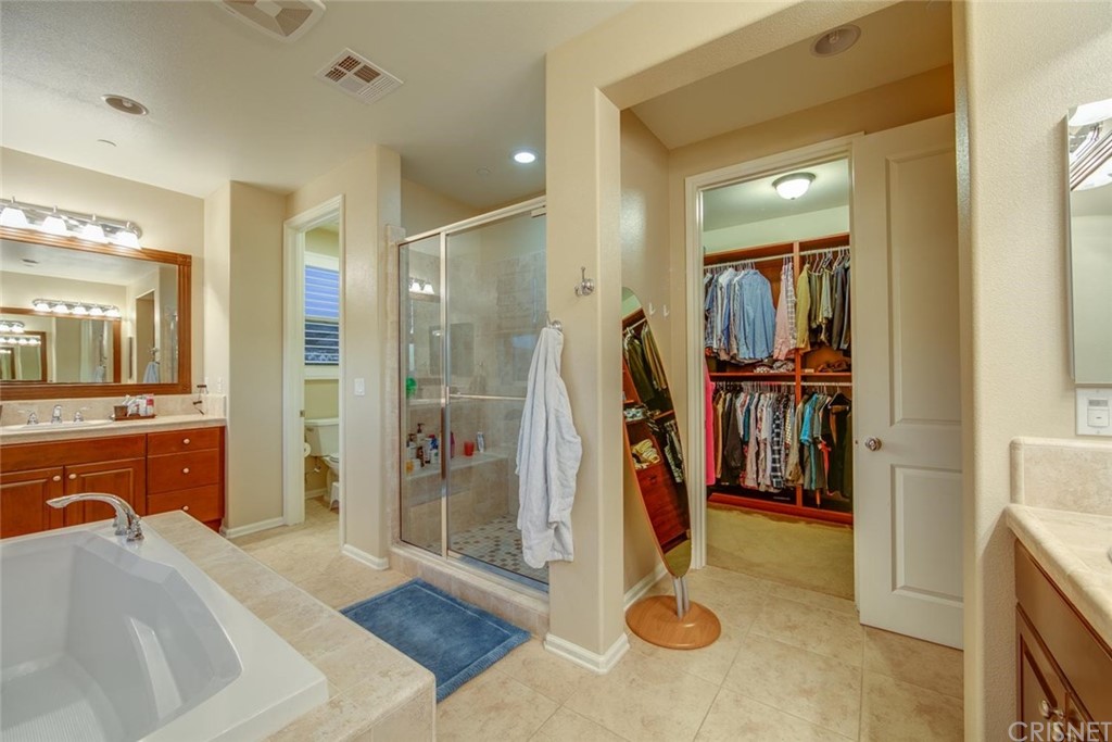 20855 Piazza Way Porter Ranch, CA 91326 - Photo 18 of 38 a en suite bathroom with a tub shower and checkered floor