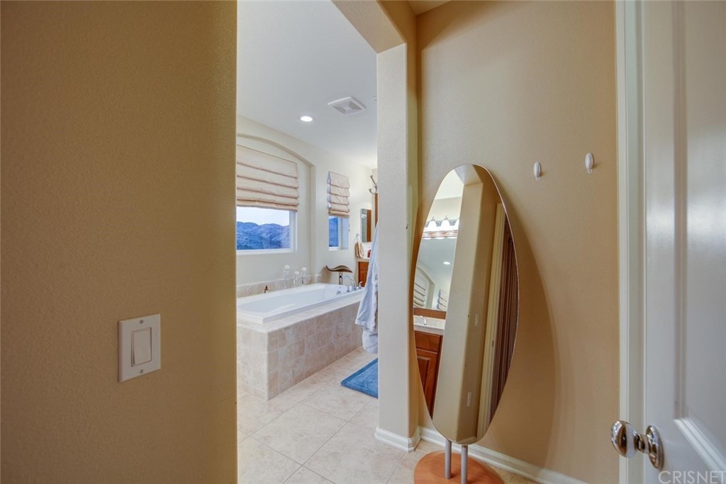 20855 Piazza Way Porter Ranch, CA 91326 - Photo 20 of 38 a view of a bathroom with a tub and shower