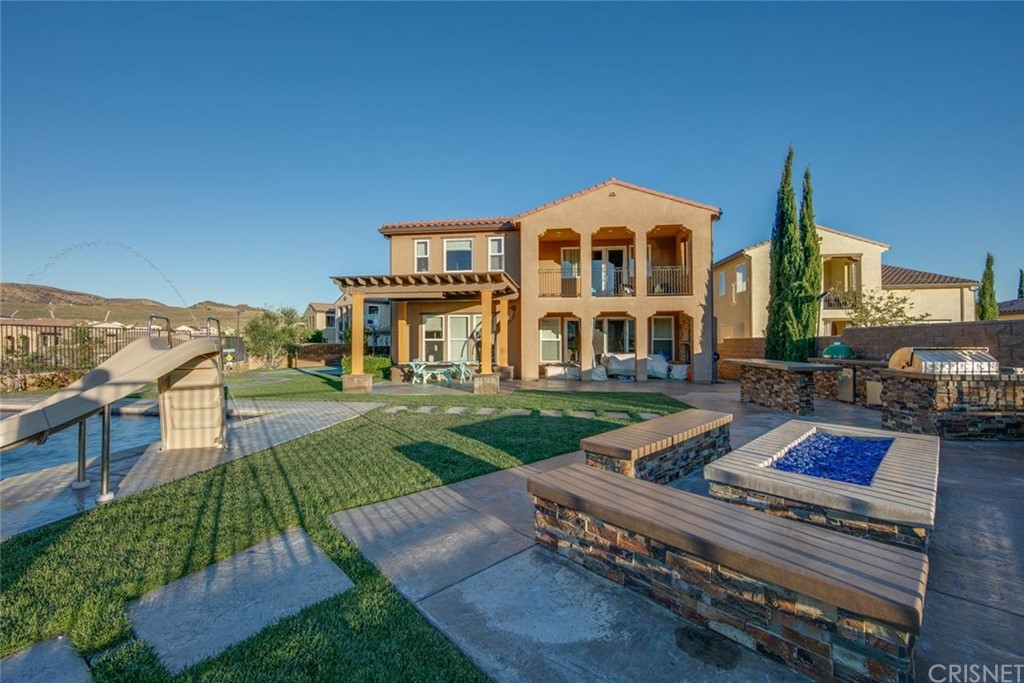 20855 Piazza Way Porter Ranch, CA 91326 - Photo 28 of 38 a view of a house with backyard porch and sitting area