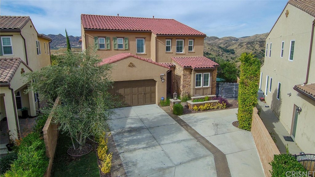 20855 Piazza Way Porter Ranch, CA 91326 - Photo 37 of 38 a front view of a house with garden