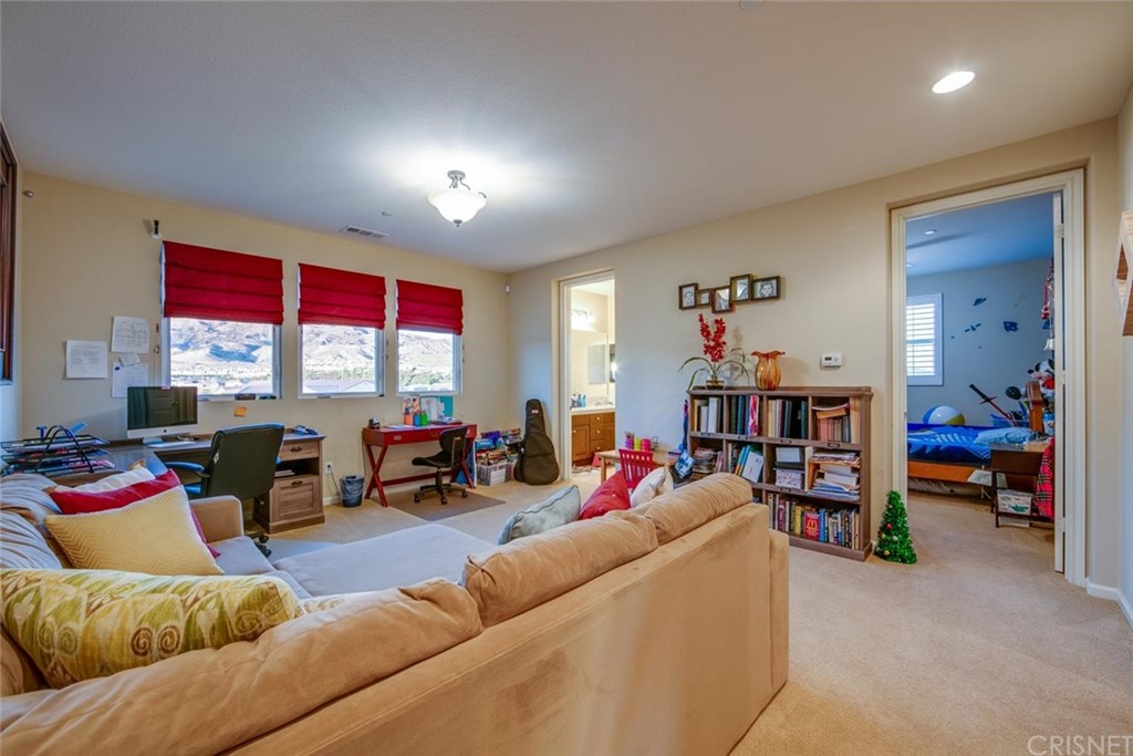 20855 Piazza Way Porter Ranch, CA 91326 - Photo 9 of 38 a living room with furniture and a flat screen tv