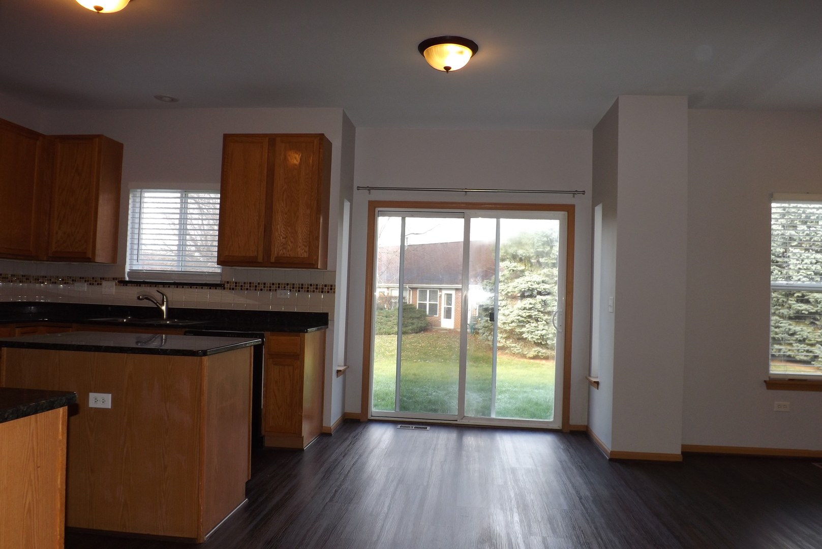 1865 Cattail Circle Aurora, IL 60504 - Photo 3 of 14 a kitchen with granite countertop a stove a sink and a large window