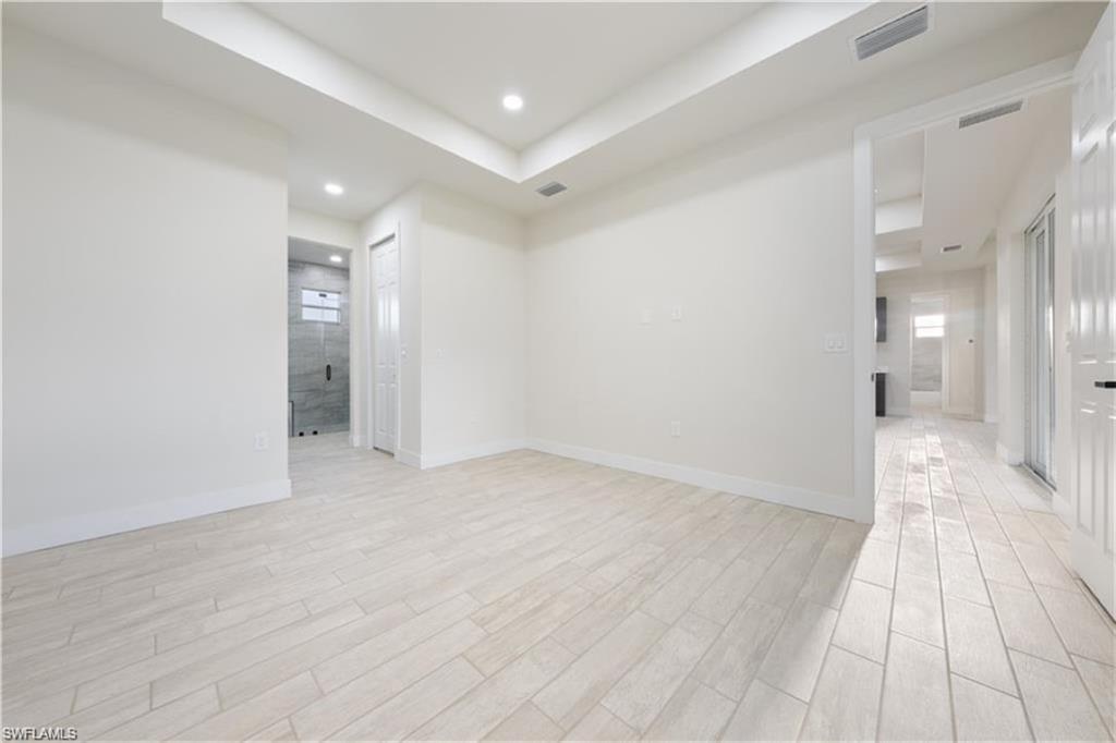 3008 23rd Street Southwest Lehigh Acres, FL 33976 - Photo 2 of 10 a view of a big room with wooden floor and a bathroom