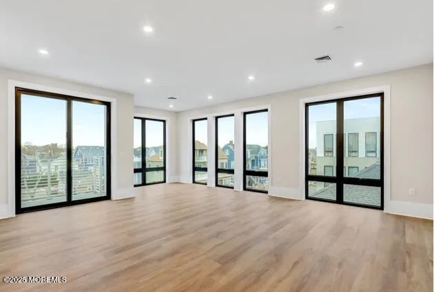 a view of an empty room with windows and city view
