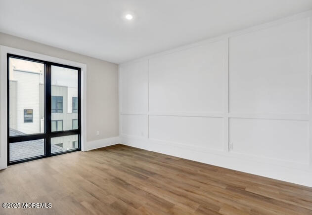 215 2nd Avenue, Unit 106 Asbury Park, NJ 07712 - Photo 13 of 24 wooden floor in an empty room with a window