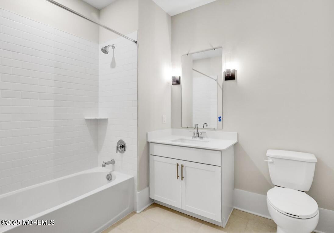 215 2nd Avenue, Unit 106 Asbury Park, NJ 07712 - Photo 15 of 24 a bathroom with a toilet sink and mirror