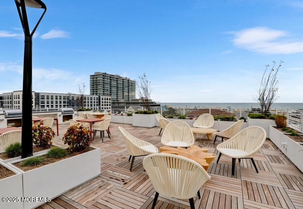 215 2nd Avenue, Unit 106 Asbury Park, NJ 07712 - Photo 17 of 24 a view of a roof deck with couches and potted plants