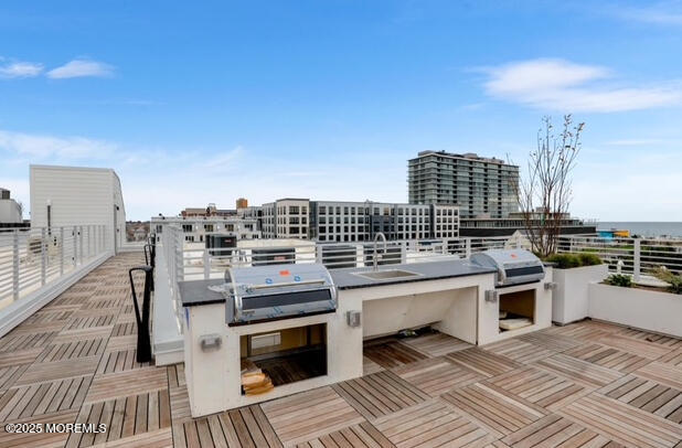 215 2nd Avenue, Unit 106 Asbury Park, NJ 07712 - Photo 18 of 24 a view of a roof deck with couches and wooden floor