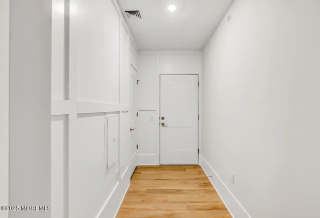 a view of hallway with wooden floor