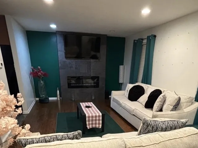 a living room with furniture and a flat screen tv