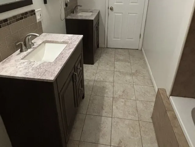 a bathroom with a granite countertop sink a toilet and granite