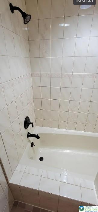 444 West 3rd Street, Unit 9 Bethlehem, PA 18015 - Photo 8 of 16 Clean, tiled bathtub and shower combination ready for relaxation.