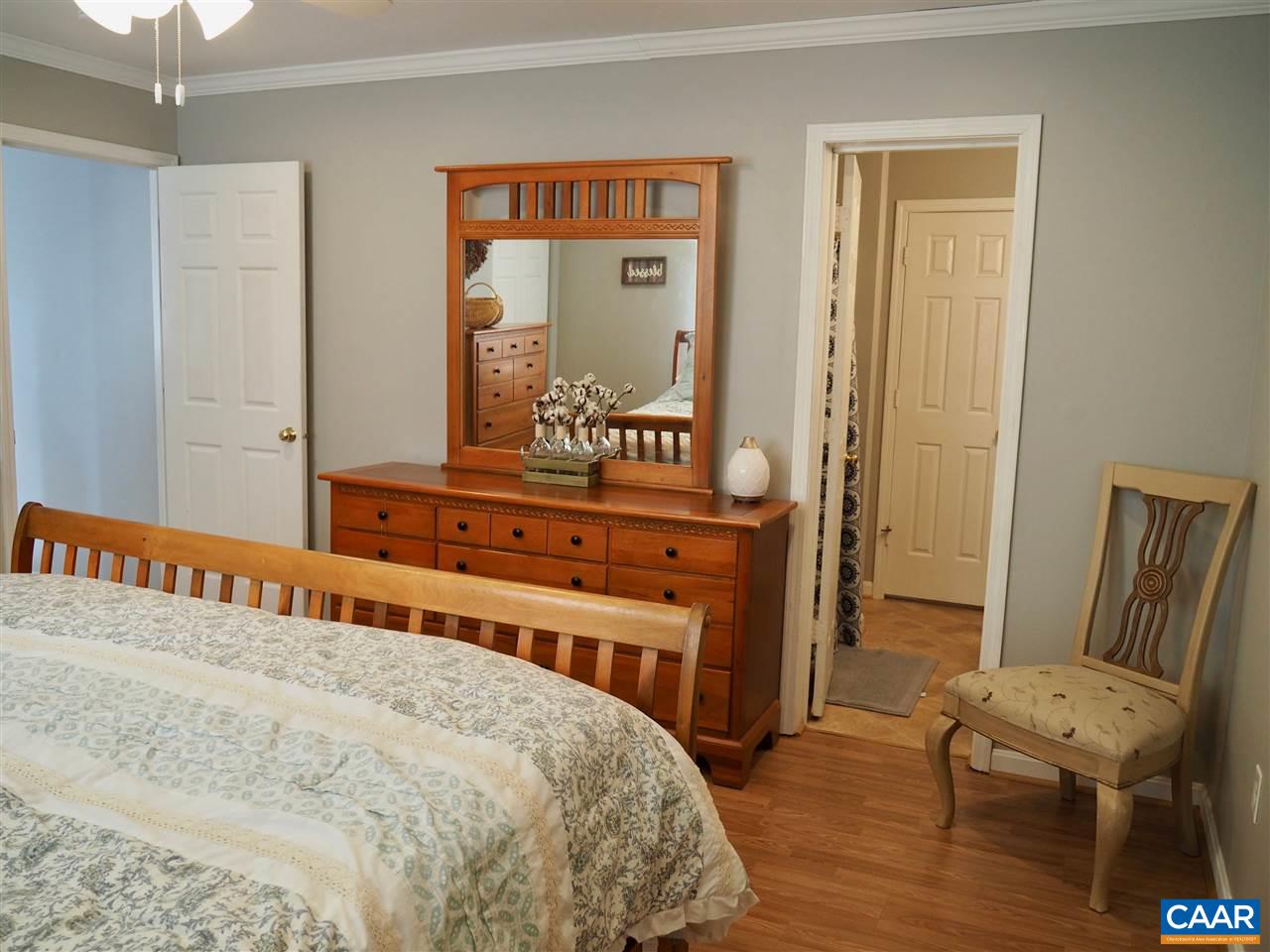 2880 Craigland Road Charlottesville, VA 22902 - Photo 19 of 48 a bedroom with a bed and wooden floor