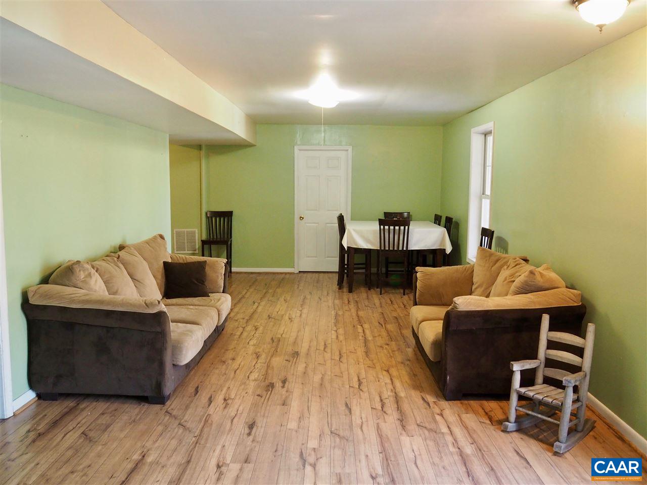 2880 Craigland Road Charlottesville, VA 22902 - Photo 36 of 48 a living room with furniture and a wooden floor