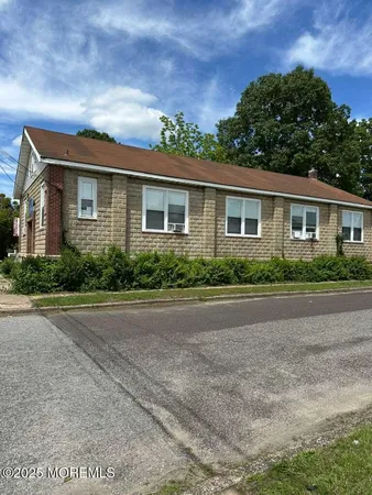 a front view of a house with large windows
