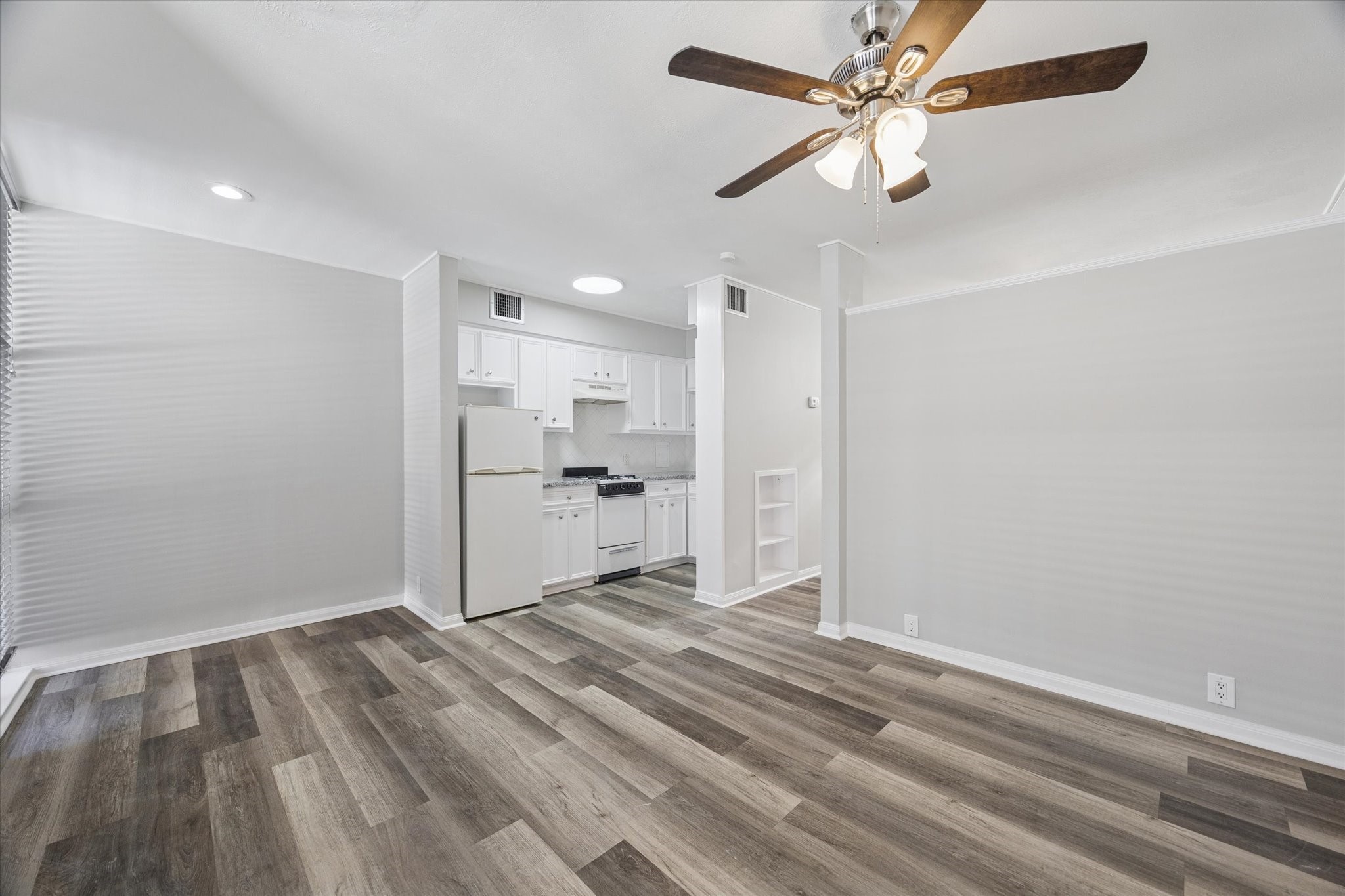 1901 Whitney Street, Unit 7 Houston, TX 77006 - Photo 2 of 10 a view of a kitchen with a dishwasher cabinets and wooden floor