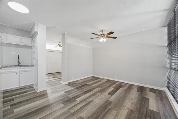 a view of a room with wooden floor and cabinet