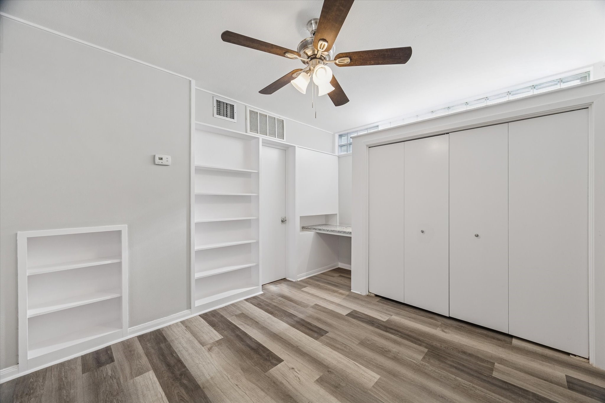 1901 Whitney Street, Unit 7 Houston, TX 77006 - Photo 6 of 10 a view of an empty room with a ceiling fan window and a ceiling fan