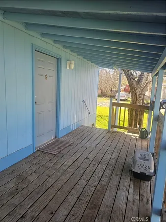 a view of outdoor space with wooden deck and furniture