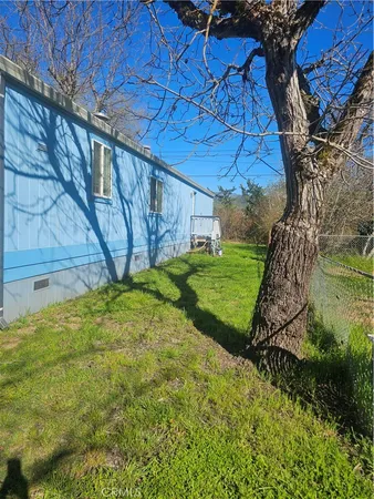 a view of backyard with wooden fence