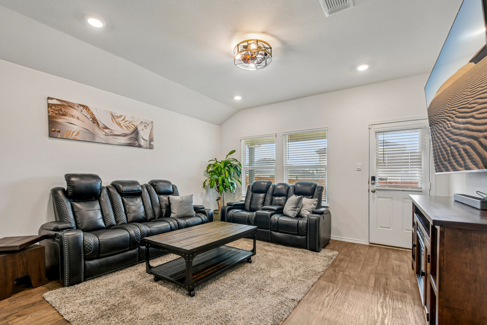519 Sandringham Loop Kyle, TX 78640 - Photo 7 of 32 Living room featuring vaulted ceiling, light wood-style floors, and recessed lighting