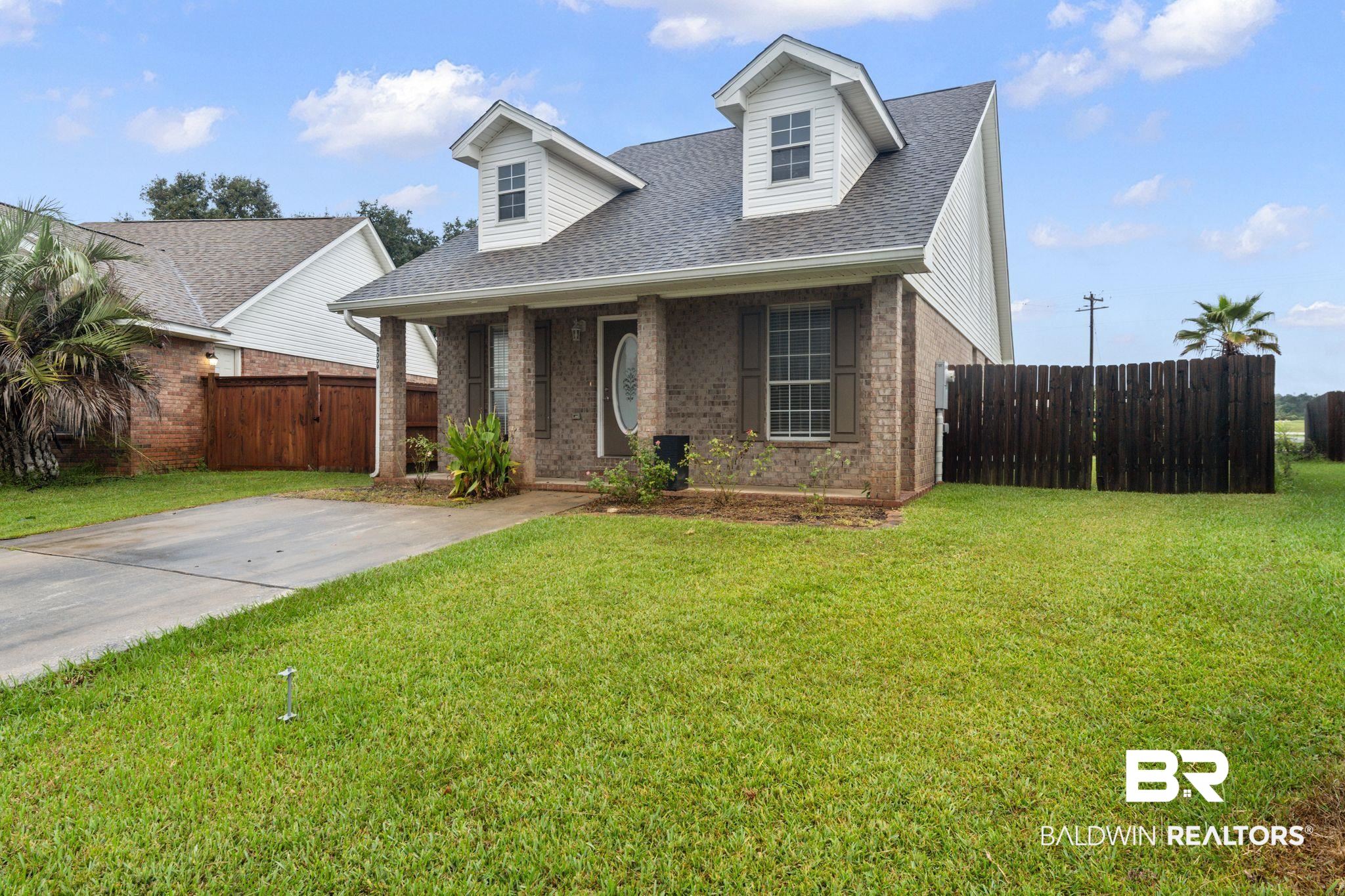 4009 Kendallbrook Loop Foley, AL 36535 - Photo 2 of 28 View of front facade featuring brick siding, roof with shingles, and a porch
