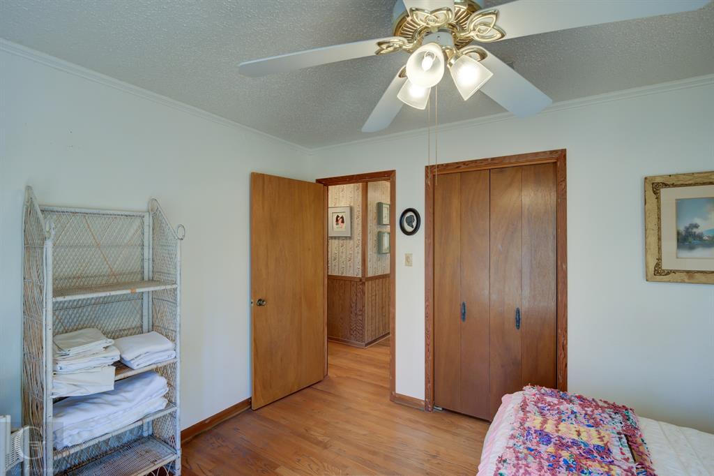 7105 Rodessa Ida Road Ida, LA 71044 - Photo 19 of 40 a bedroom with a bed and a chandelier fan