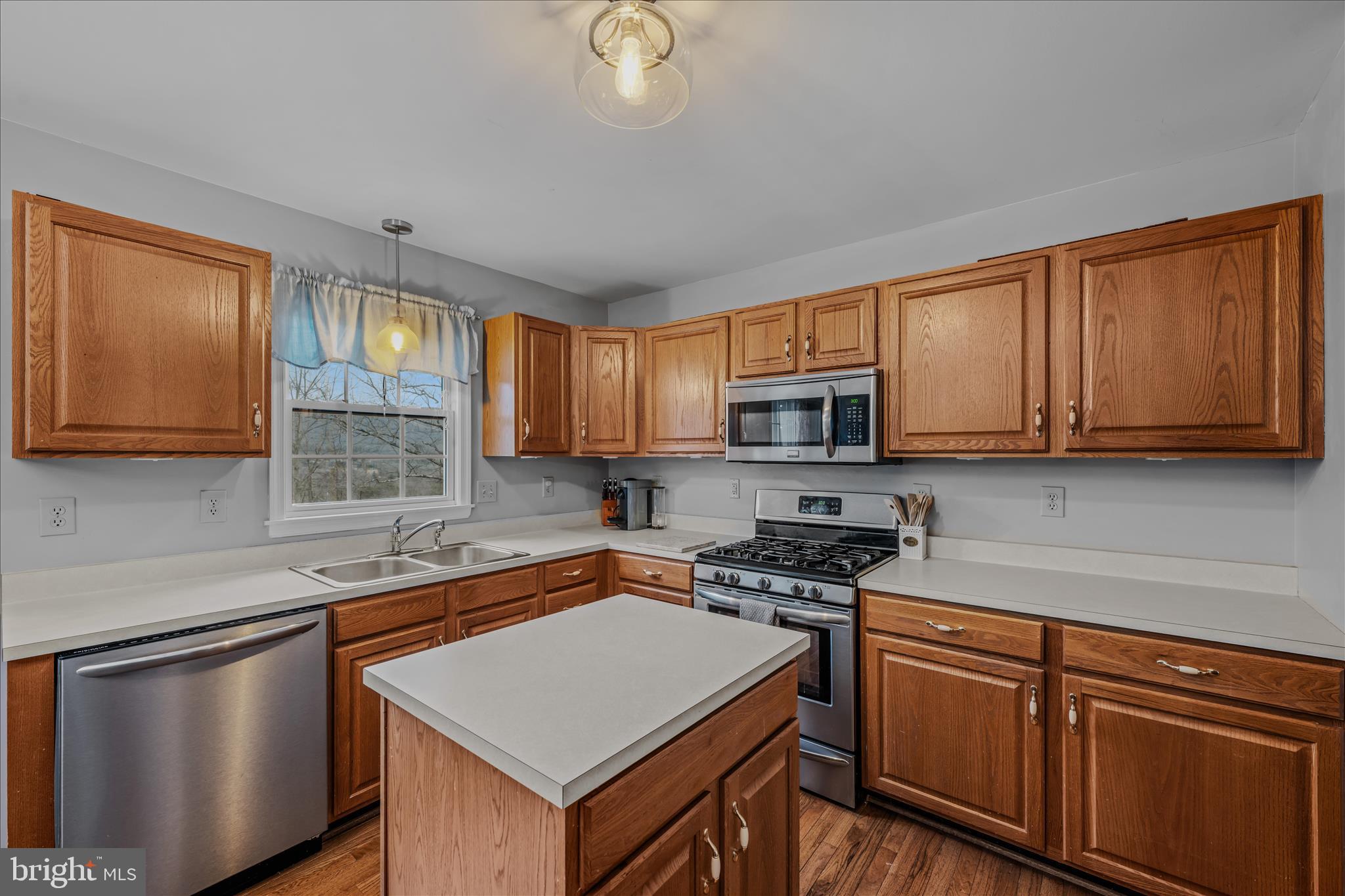 2509 Highland Ridge Road Berkeley Springs, WV 25411 - Photo 19 of 68 a kitchen with stainless steel appliances granite countertop a sink stove and microwave